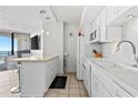 White kitchen with modern appliances and breakfast bar at 5523 North Ocean Blvd. # 1402, Myrtle Beach, SC 29577