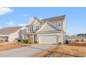 Two-story house with gray siding, a double-car garage, and a paved driveway at 556 Majorca Loop, Myrtle Beach, SC 29579
