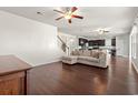 Open living room with hardwood floors, L-shaped sofa, and view into kitchen at 556 Majorca Loop, Myrtle Beach, SC 29579