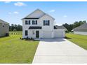Two-story house with white siding, two-car garage, and landscaping at 56 Cape Point Dr., Conway, SC 29527