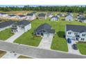 New construction neighborhood with tree-lined streets and manicured lawns at 57 Cape Point Dr., Conway, SC 29527
