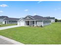 New construction home showcasing gray siding and a well-maintained lawn at 57 Cape Point Dr., Conway, SC 29527