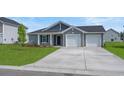 Charming single-story home showcasing a well-manicured lawn and a two-car garage at 57 Cape Point Dr., Conway, SC 29527