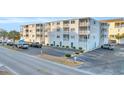 Exterior view of building showing parking and landscaping at 5709 N Ocean Blvd. # 303, North Myrtle Beach, SC 29582
