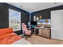Comfortable bedroom features a black accent wall, LED lighting, and a window at 589 Talisman Trail, Longs, SC 29568