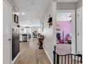 Inviting hallway with wood floors, leading to a kitchen and bedroom at 589 Talisman Trail, Longs, SC 29568