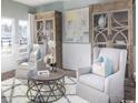 Cozy sitting room featuring hardwood floors, large windows, and stylish furniture at 718 Isle Verde Dr, Myrtle Beach, SC 29579