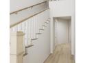 White hallway with wooden staircase and light hardwood floors at 886 Foxtail Dr. # C-39, Longs, SC 29568