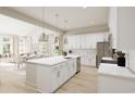 Modern white kitchen with large island and stainless steel appliances at 886 Foxtail Dr. # C-39, Longs, SC 29568