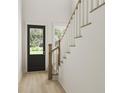 Light-filled entryway with modern staircase and black front door at 886 Foxtail Dr. # C-39, Longs, SC 29568