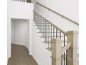 Classic wood staircase with white risers, contrasting railing, and view of the hallway at 910 Foxtail Dr. # D-45, Longs, SC 29568