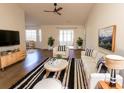 Spacious living room with hardwood floors, comfy seating, and a modern aesthetic at 9594 Sullivan Dr., Murrells Inlet, SC 29576