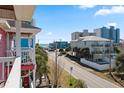 Oceanfront view from balcony; street scene with other houses at 118 Seabreeze Dr., Murrells Inlet, SC 29576