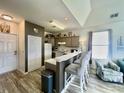 Open kitchen features a breakfast bar and stylish cabinetry at 1310 River Oaks Dr. # 2K, Myrtle Beach, SC 29579