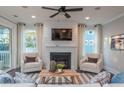 Living room with fireplace, comfortable seating, and access to a deck at 1757 Tryon Dr, Myrtle Beach, SC 29588