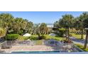 Overhead view of the sparkling swimming pool surrounded by palm trees, lawn chairs, and umbrellas overlooking the ocean at 2106 N Ocean Bl N Ocean Blvd. # 211, Myrtle Beach, SC 29577