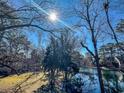 Serene view of a calm lake surrounded by lush greenery and tall trees at 211 Baslow Ct. # 2-D, Myrtle Beach, SC 29572