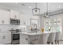 Modern kitchen with white cabinets, stainless steel appliances, and a large island at 244 Gloucester Way, Little River, SC 29566