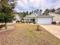 Charming single-story home with well-maintained lawn and a two-car garage in a friendly neighborhood at 344 Tall Palms Way, Little River, SC 29566