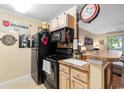 Black appliances, wood cabinets, and kitchen island with seating at 3786 Hitchcock Way # 312, Myrtle Beach, SC 29577
