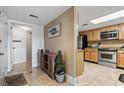 Inviting condo entryway that leads to a delightful kitchen with modern stainless steel appliances and granite countertops at 4390 Bimini Ct. # 206-C, Little River, SC 29566