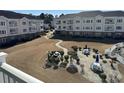 Ground level view of condo courtyard with patio tables and grills at 4860 Carnation Circle # 304, Myrtle Beach, SC 29579