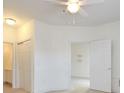 Neutral bedroom features 6-panel doors, a ceiling fan, and a view into another room at 5011 Harvest Dr. # 101, Myrtle Beach, SC 29579