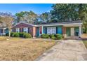 Front view of a charming brick ranch house with green accents at 534 Juniper Dr. # 534, Myrtle Beach, SC 29577