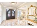 Elegant entryway with double doors, tile floors, and views into living areas at 5816 Woodside Ave., Myrtle Beach, SC 29577