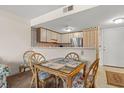 Small dining area with glass-top table and chairs at 5905 S Kings Hwy. # 4103, Myrtle Beach, SC 29575