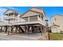 Inviting beach home featuring a large deck and ample parking space underneath at 6001- P04 S Kings Highway, Myrtle Beach, SC 29575