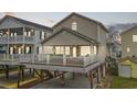 Inviting beach home at dusk featuring a large deck and outdoor entertaining space at 6001- P04 S Kings Highway, Myrtle Beach, SC 29575