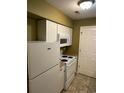 White appliances and cabinets in this galley kitchen at 615 Carter Ln. # B4, Conway, SC 29526