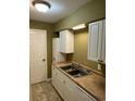 Kitchen features white cabinets, double sink, and appliances at 615 Carter Ln. # B4, Conway, SC 29526