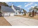 Two-story house with gray siding, blue accents, and a two-car garage at 641 Blackstone Dr., Myrtle Beach, SC 29588