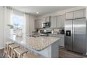 Modern kitchen with gray cabinets, granite countertops, and stainless steel appliances at 7010 Shooting Star Way, Myrtle Beach, SC 29579