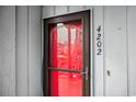Condo unit entrance with a red door and security features at 7700 Porcher Dr. # 4202, Myrtle Beach, SC 29572