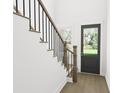 Modern staircase with wooden railing and dark metal balusters at 902 Foxtail Dr. # D-43, Longs, SC 29568