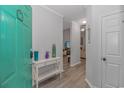 Inviting entryway with teal door, console table, and view into living area at 9772 Leyland Dr. # 10, Myrtle Beach, SC 29572