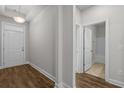 Bright hallway with hardwood floors leading to a bathroom and entrance at 1208 Nw Calabash Station Blvd., Calabash, NC 28467