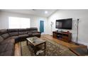 Living room featuring sectional sofa, large TV, and wood floors at 132 Blue Jacket Dr., Galivants Ferry, SC 29544