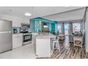 Open kitchen with granite island, stainless steel appliances, and teal accents at 1605 S Ocean Blvd. # 1113, Myrtle Beach, SC 29577