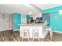 Open concept kitchen with white cabinets, granite countertops and stainless steel appliances at 1605 S Ocean Blvd. # 1113, Myrtle Beach, SC 29577