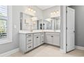 Double vanity bathroom with gray cabinets and a large mirror at 208 Switch Grass Ct., Myrtle Beach, SC 29579