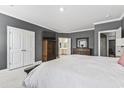 Spacious main bedroom with carpeting, large bed, and en-suite bathroom at 208 Switch Grass Ct., Myrtle Beach, SC 29579