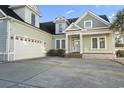 Stunning home showcasing a manicured lawn, a two-car garage, and beautiful curb appeal at 2113 Clematis Ct., Myrtle Beach, SC 29579