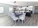 Spacious dining area with a large blue table and white chairs at 229 South Waccamaw Dr., Garden City Beach, SC 29576