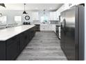 Modern kitchen featuring a large island, stainless steel appliances, and white cabinets at 229 South Waccamaw Dr., Garden City Beach, SC 29576