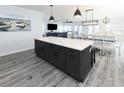 Large kitchen island with white quartz countertop and dark lower cabinets at 229 South Waccamaw Dr., Garden City Beach, SC 29576