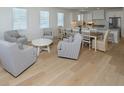 Open-concept living and dining area features hardwood floors and natural light at 229 South Waccamaw Dr., Garden City Beach, SC 29576